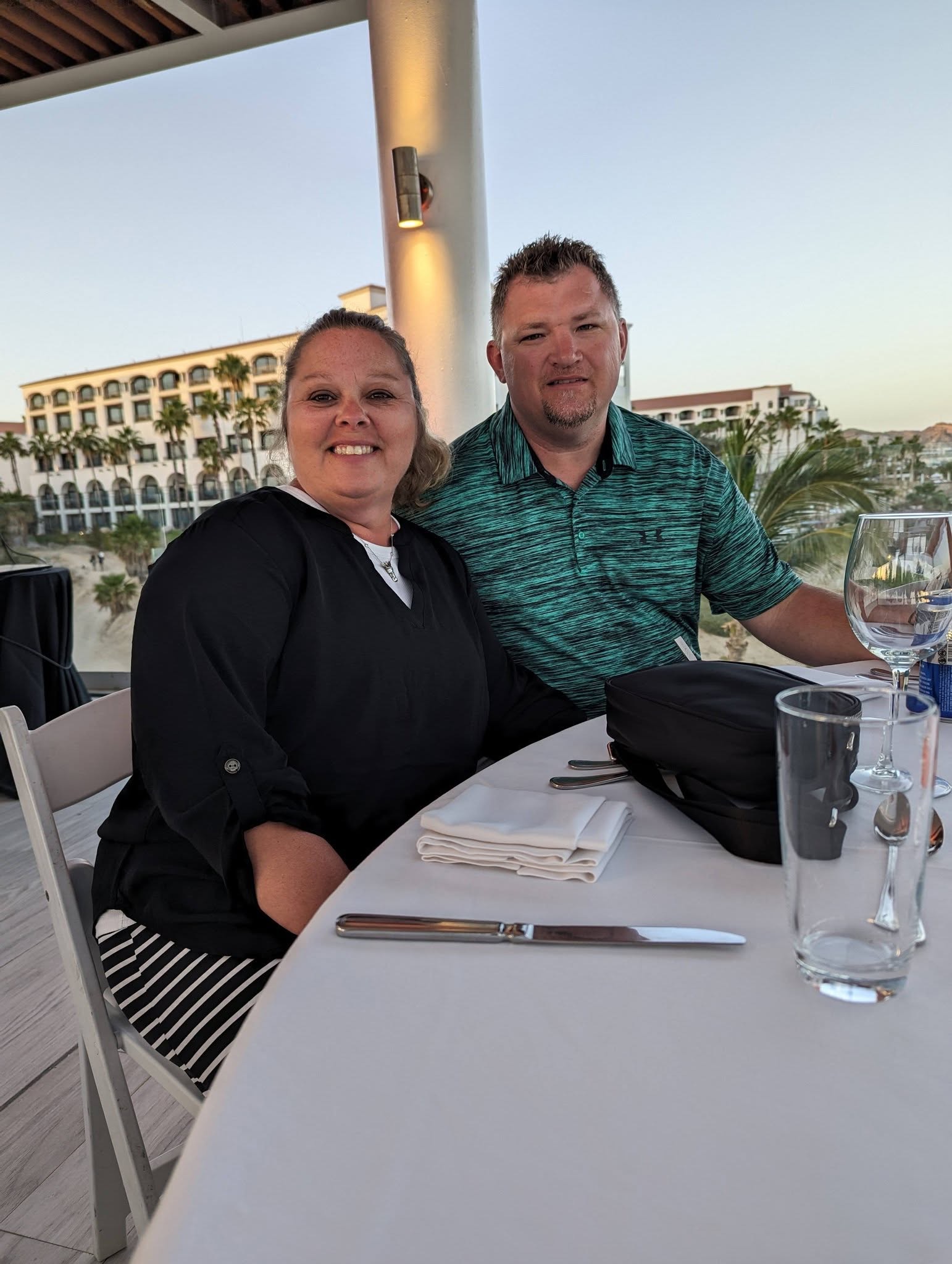 Jenny with her husband Tom enjoying dinner at an oceanside resort